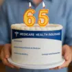 65th birthday cake with number candles and a Medicare card design wrap.
